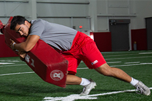 High School football player practicing fight to finish.
