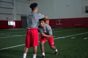 High School football player practicing fight to prepare.