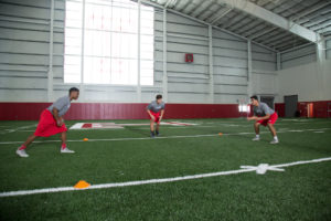 High School football player practicing fight to track.