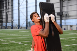 High School football player working on form tackle with a Riddell Tackle Dummy.