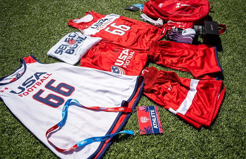 USA Football Select Bowl athlete gear including jerseys, shorts, and equipment on field.