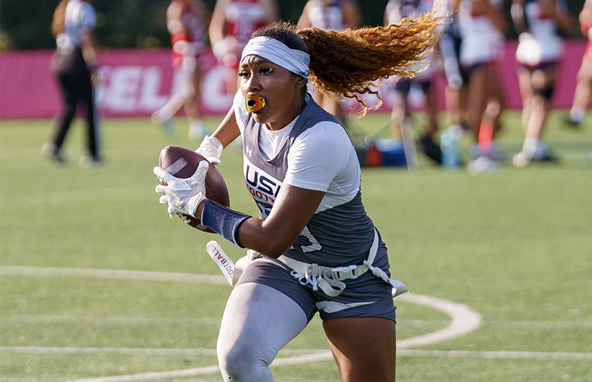 USA Football Select Bowl athlete running with football during flag football game action
