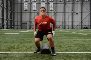 High School Athlete working on shoulder tackling fundamentals.