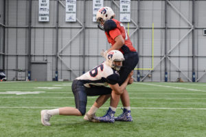 High School football player going through the Thigh and Drive tackling drill.
